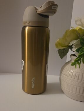 Owala Gold Stainless Steel Water Bottle with Beige Lid